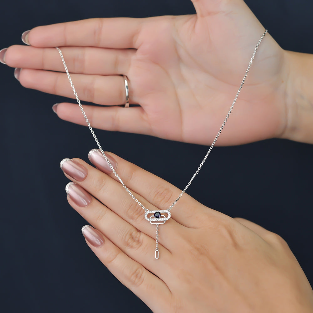 Delicate necklace featuring a pavé oval frame centered with a dark crystal drop