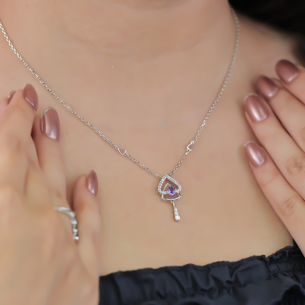 Silver chain necklace with a layered triangular pendant and purple gem
