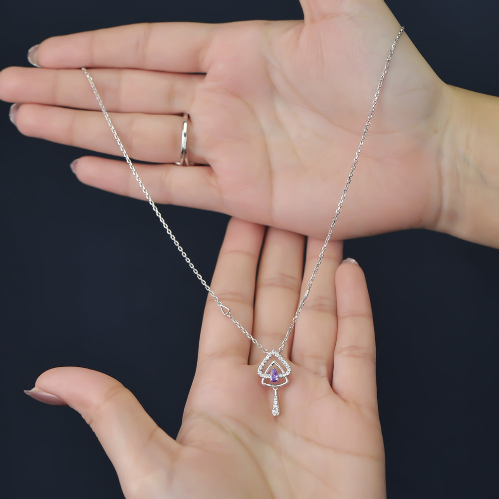 Silver chain necklace with a layered triangular pendant and purple gem