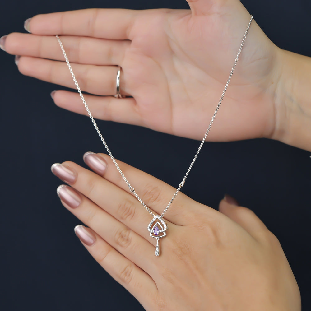 Silver chain necklace with a layered triangular pendant and purple gem