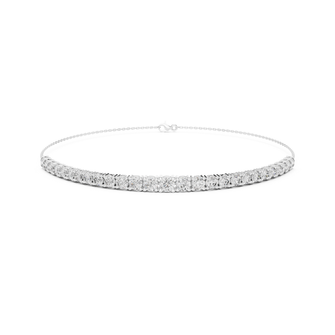 Graduating cluster chain bracelet with baguette and round stone centre detailing