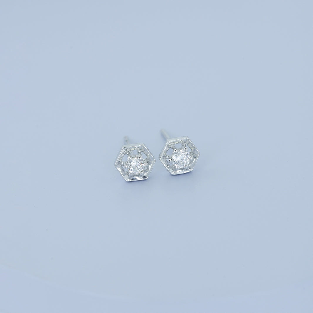 Hexagon stud earrings with geometric frame and raised round centre