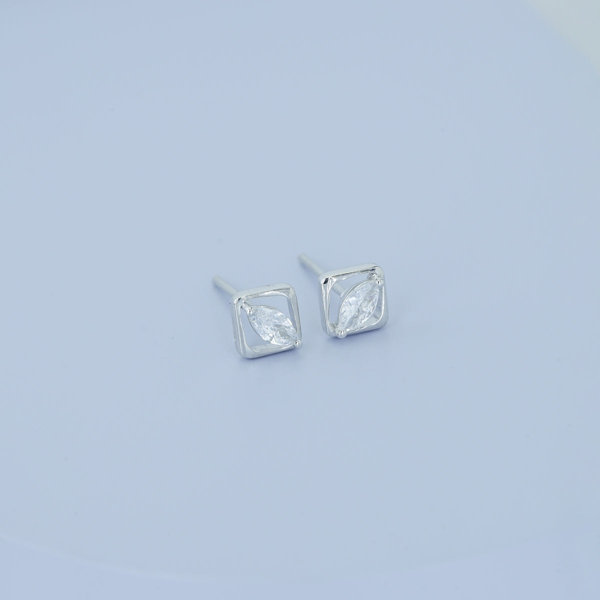 Marquise stud earrings with tilted square open frame border