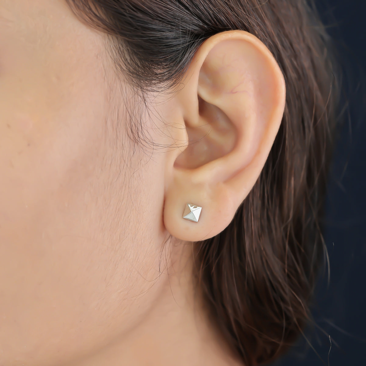 Modern pyramid stud earrings with smooth square base and raised geometric peak