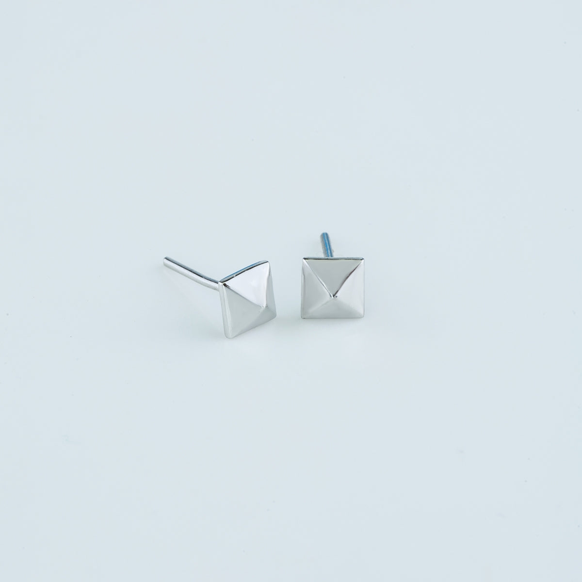 Modern pyramid stud earrings with smooth square base and raised geometric peak