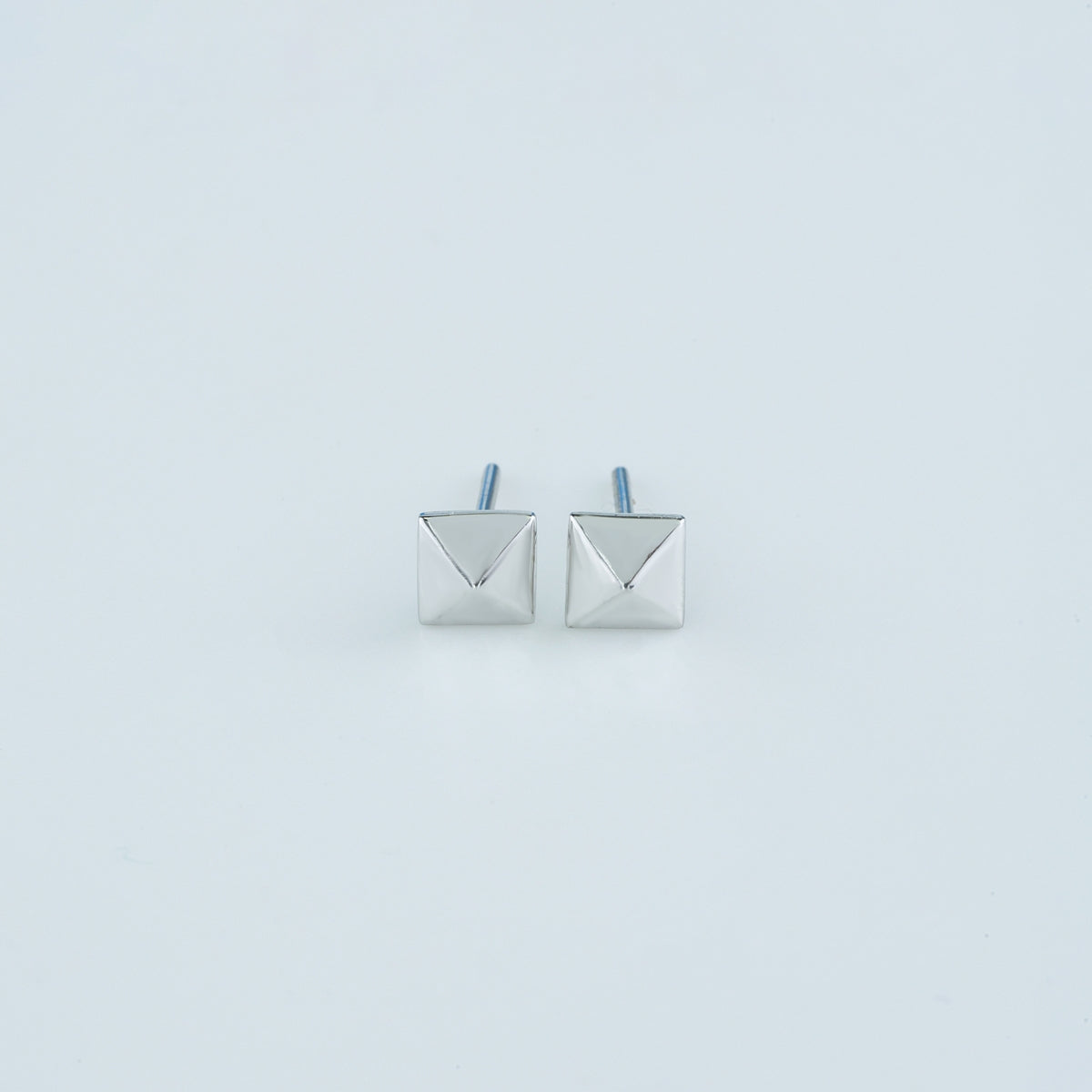Modern pyramid stud earrings with smooth square base and raised geometric peak