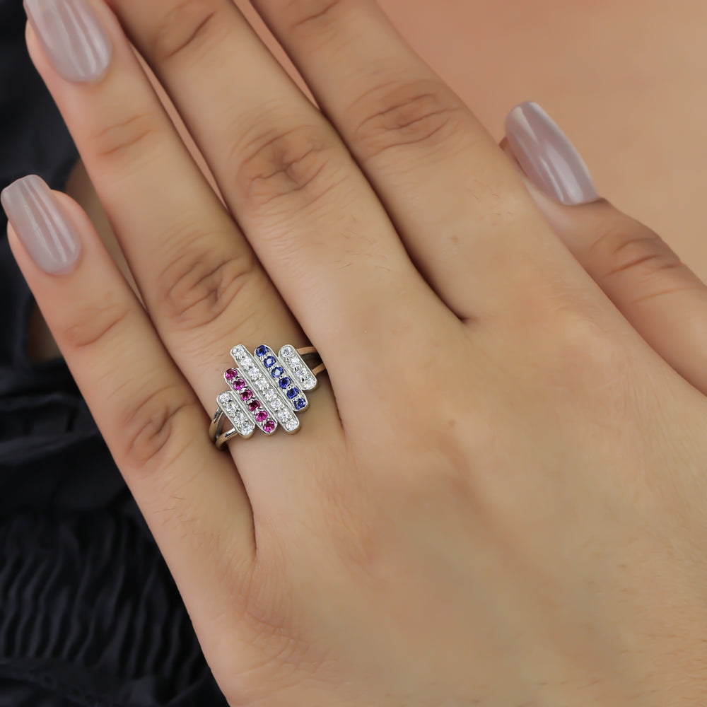 Statement ring featuring vertical rows of clear, pink, and dark blue stones