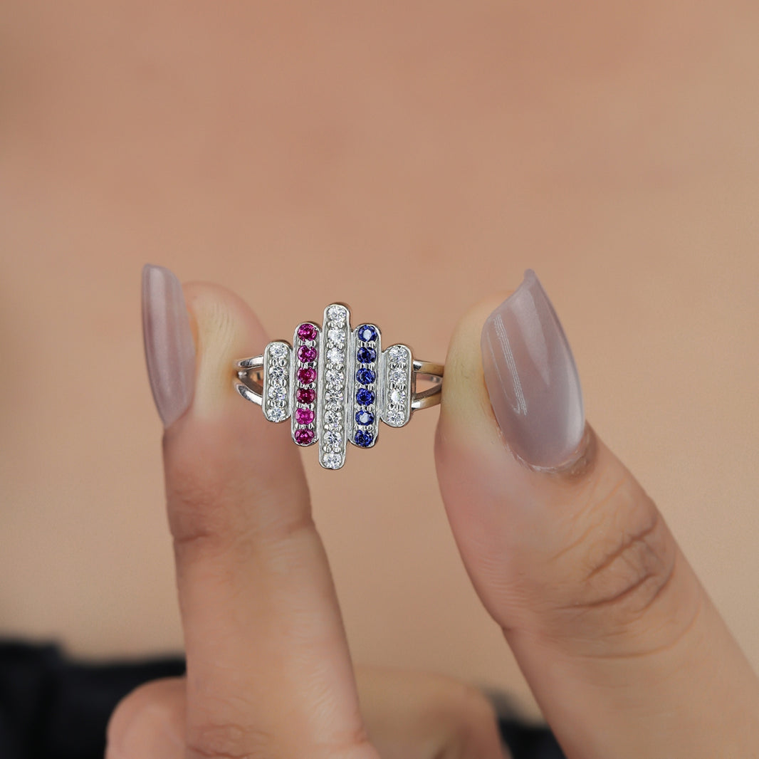 Statement ring featuring vertical rows of clear, pink, and dark blue stones