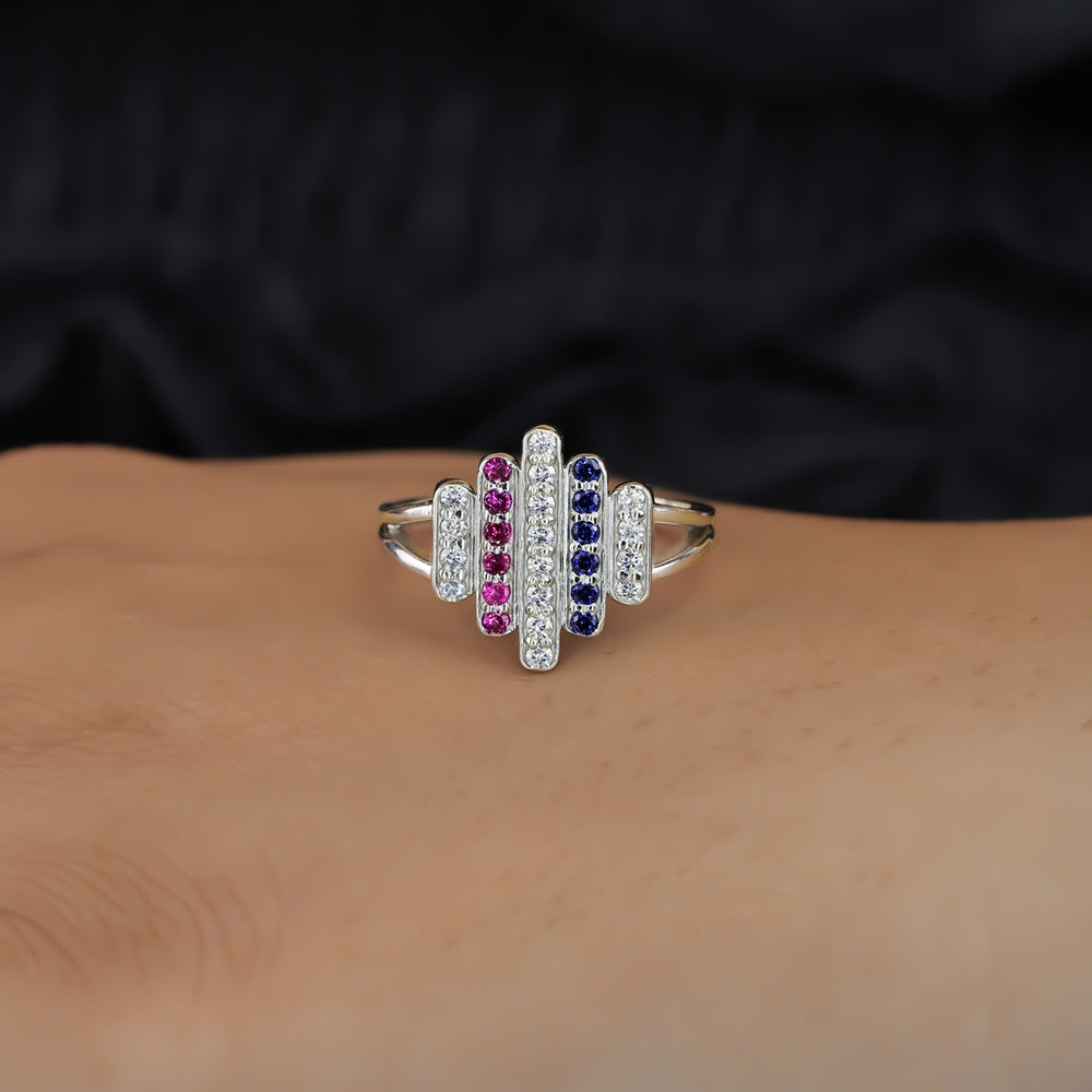 Statement ring featuring vertical rows of clear, pink, and dark blue stones