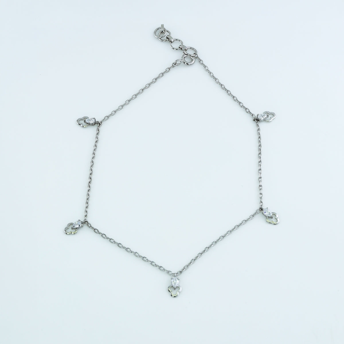 Pear drop charm anklet with delicate chain and five dangling pear shaped stone charms