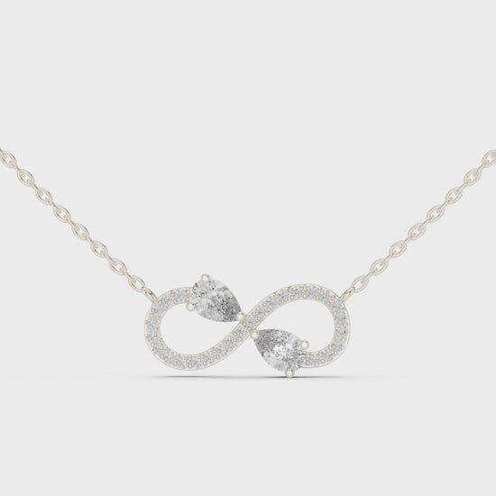 Infinity symbol pave diamond pendant necklace with dual pear cut stone accent