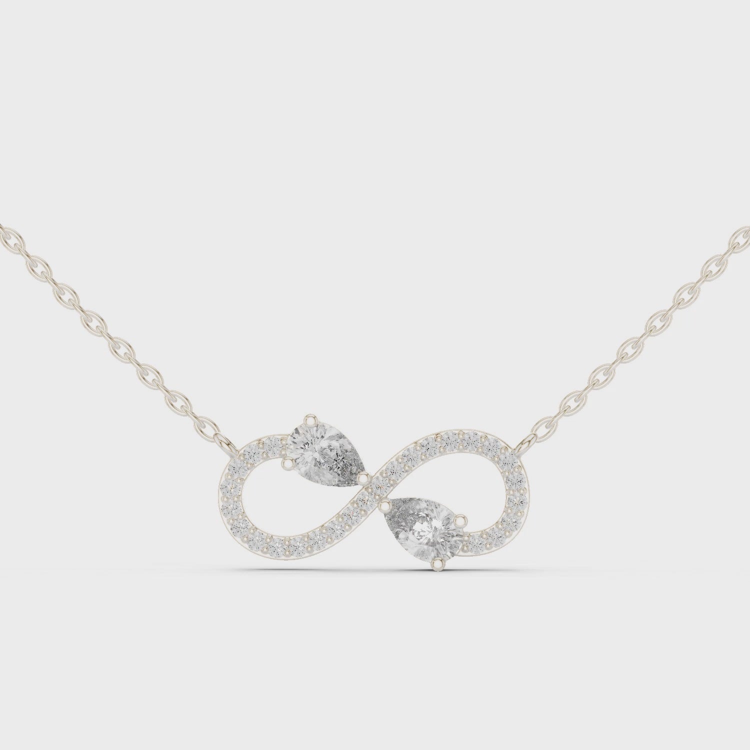 Infinity symbol pave diamond pendant necklace with dual pear cut stone accent