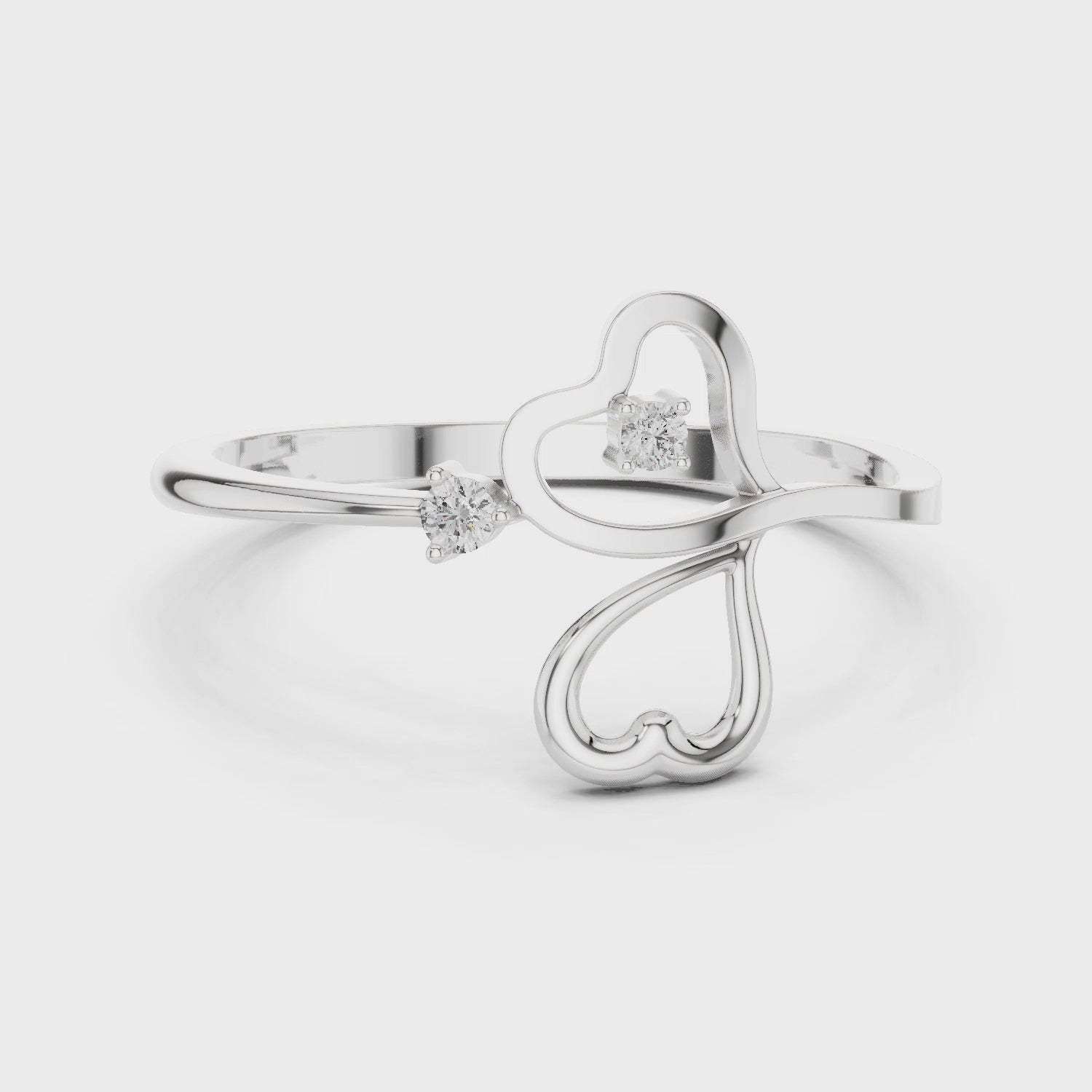 Triple heart open bypass ring with interlinked outline hearts and solitaire accents