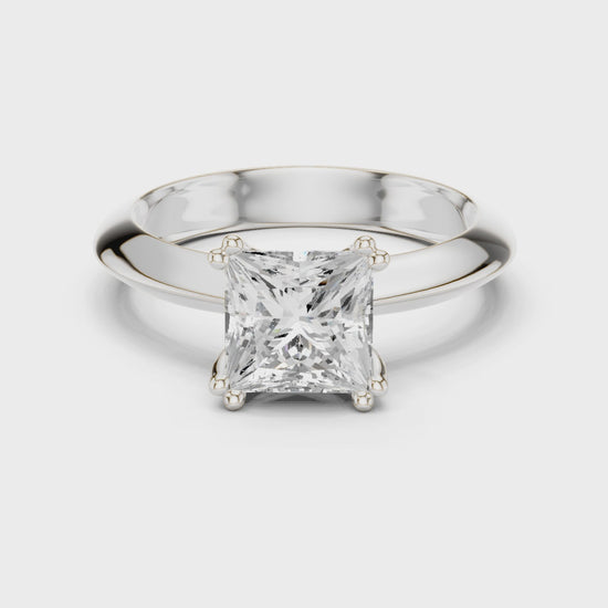Princess cut solitaire engagement ring with four prong setting and smooth tapered band