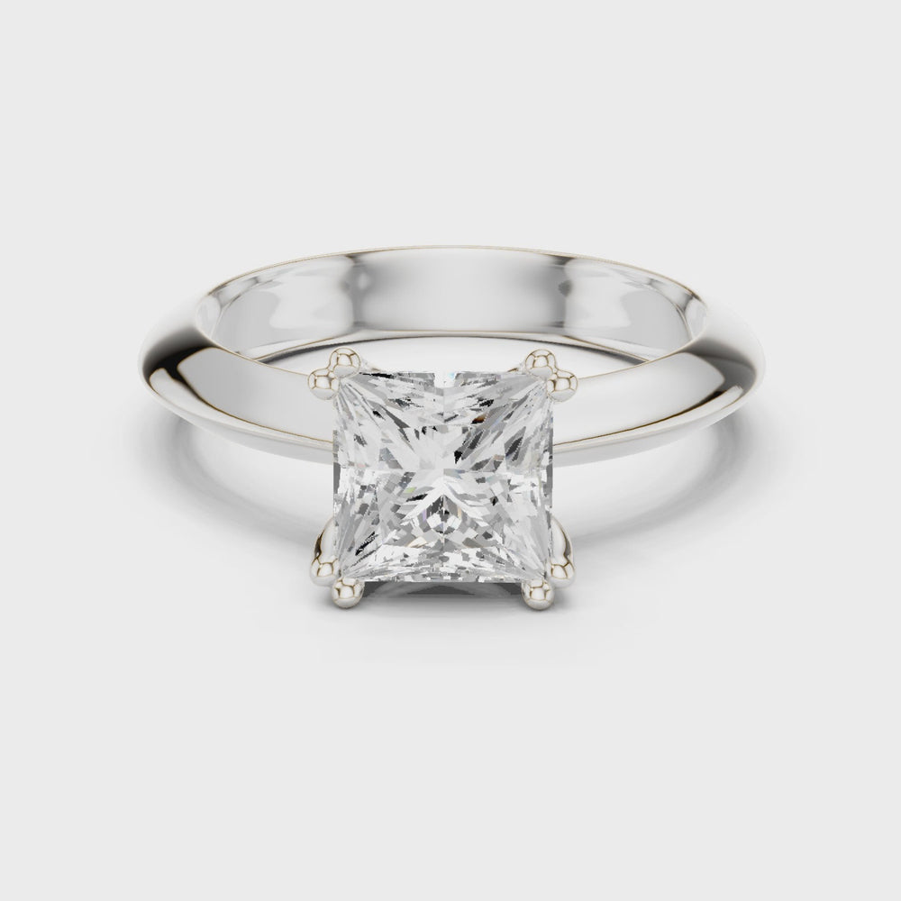 Princess cut solitaire engagement ring with four prong setting and smooth tapered band