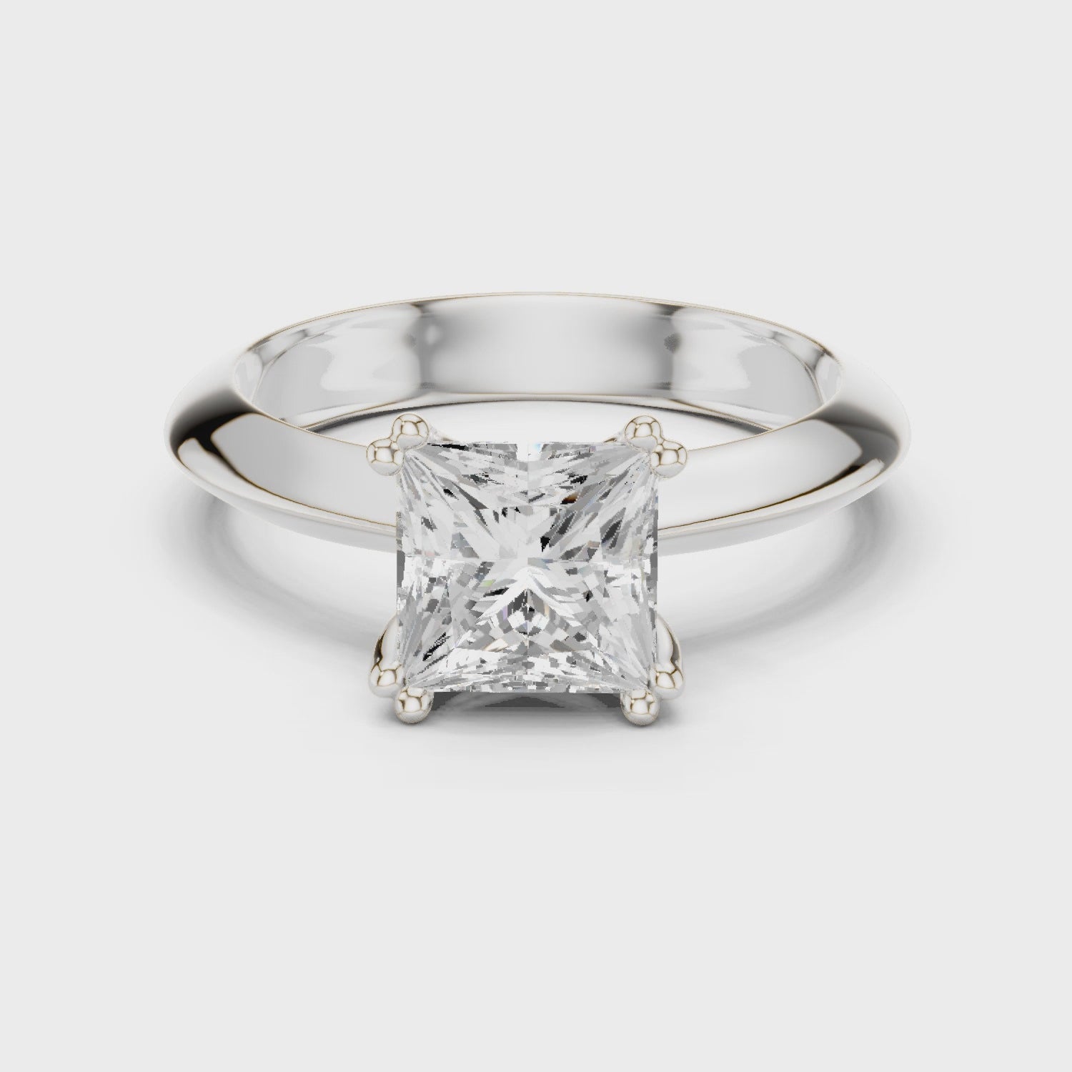 Princess cut solitaire engagement ring with four prong setting and smooth tapered band