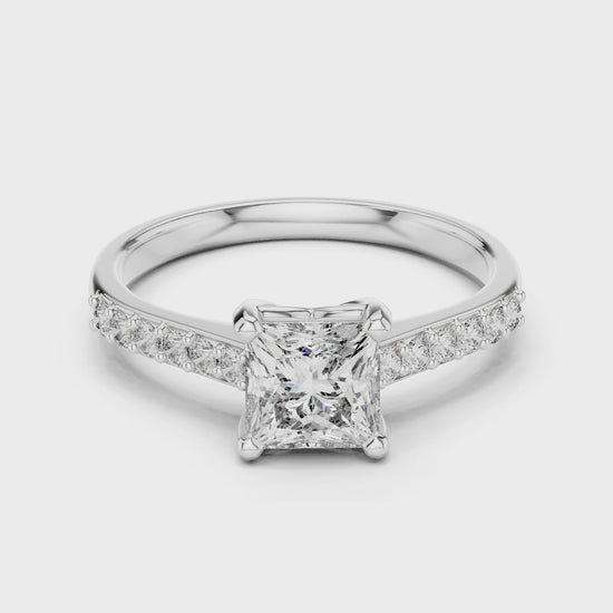 Princess cut engagement ring with four prong setting and studded shoulders