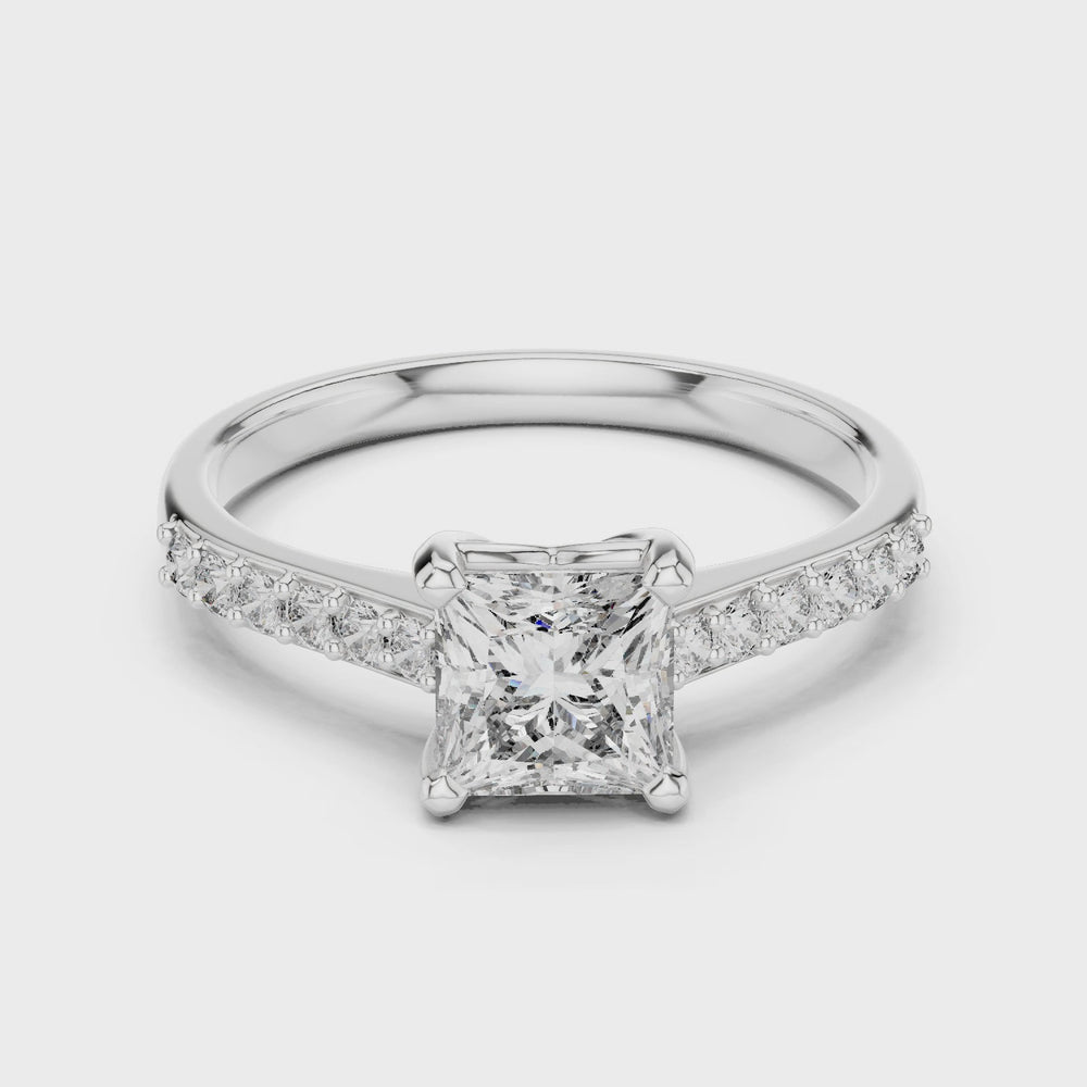 Princess cut engagement ring with four prong setting and studded shoulders