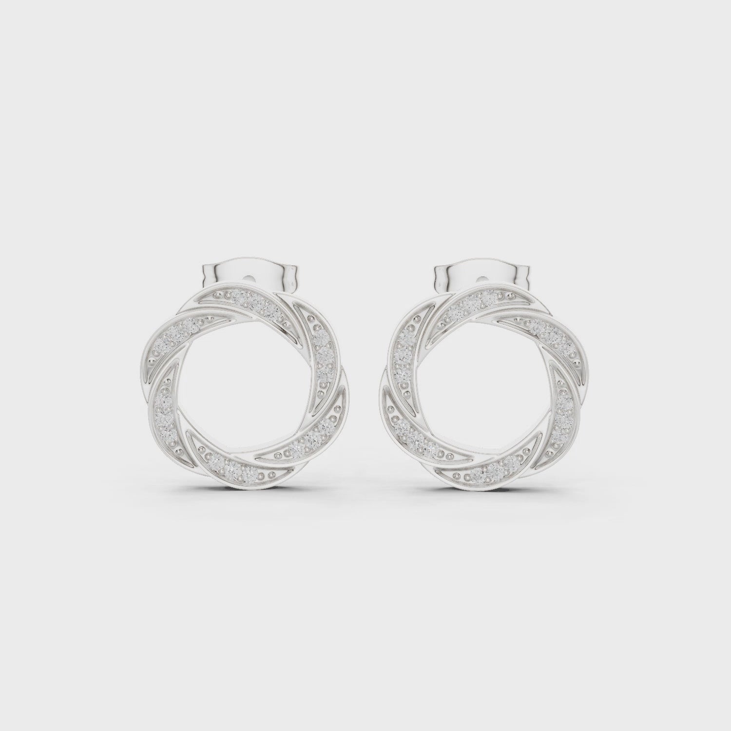 Twisted hoop pave diamond earrings with intertwined design and push back setting