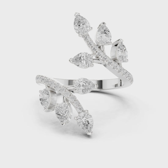 Multi stone floral bypass ring with scattered pear and pave set open band