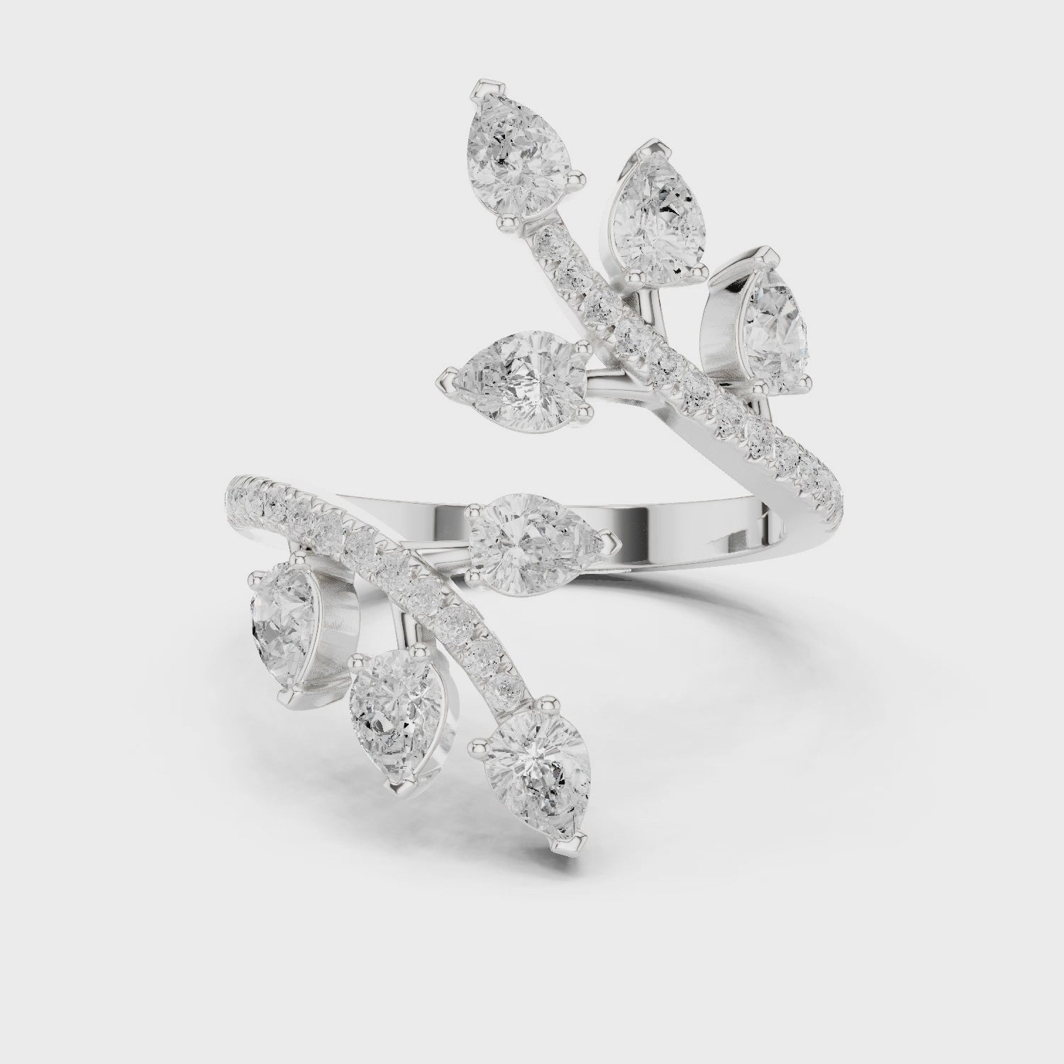 Multi stone floral bypass ring with scattered pear and pave set open band