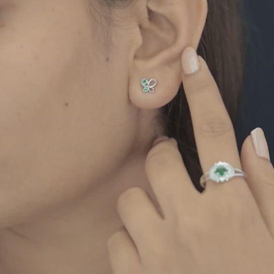 Green butterfly stud earrings with open loop wings and round green stone accents