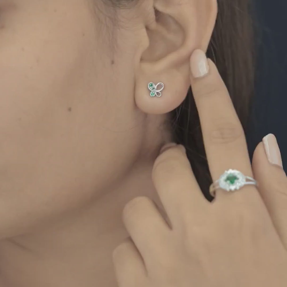 Green butterfly stud earrings with open loop wings and round green stone accents