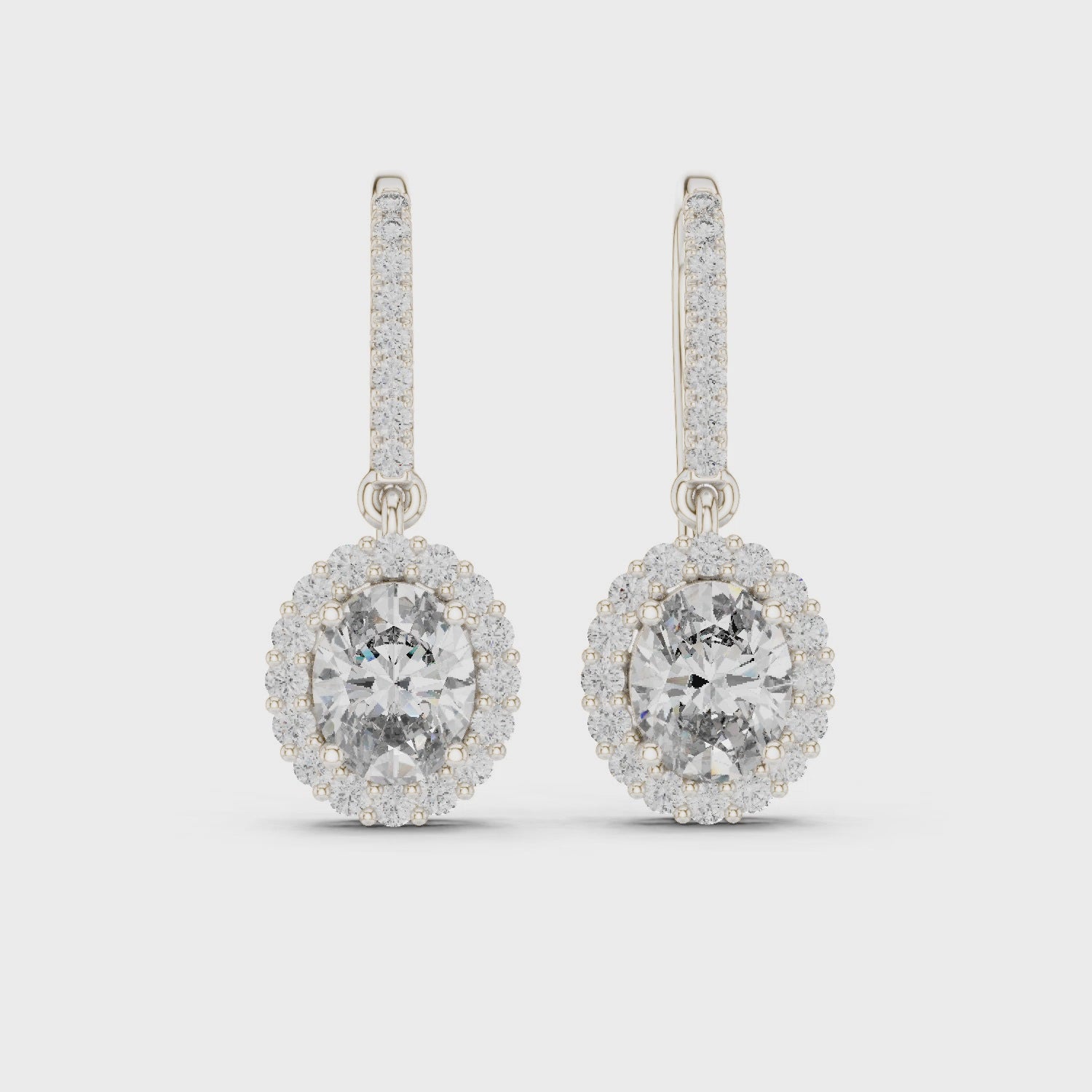 Halo solitaire hook drop earrings with pave set stone detailing