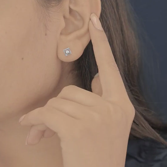 Square claw stud earrings with tilted open frame and raised round centre