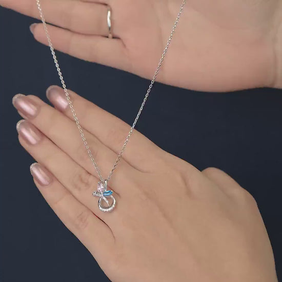 Silver chain necklace with a crescent pendant set with pink and blue stones
