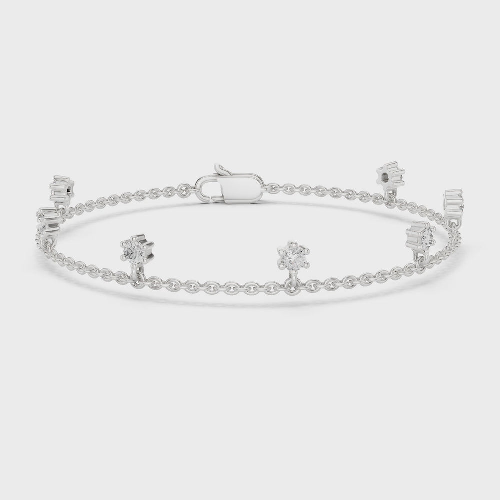 Floating station charm bracelet with prong set round stone station detailing