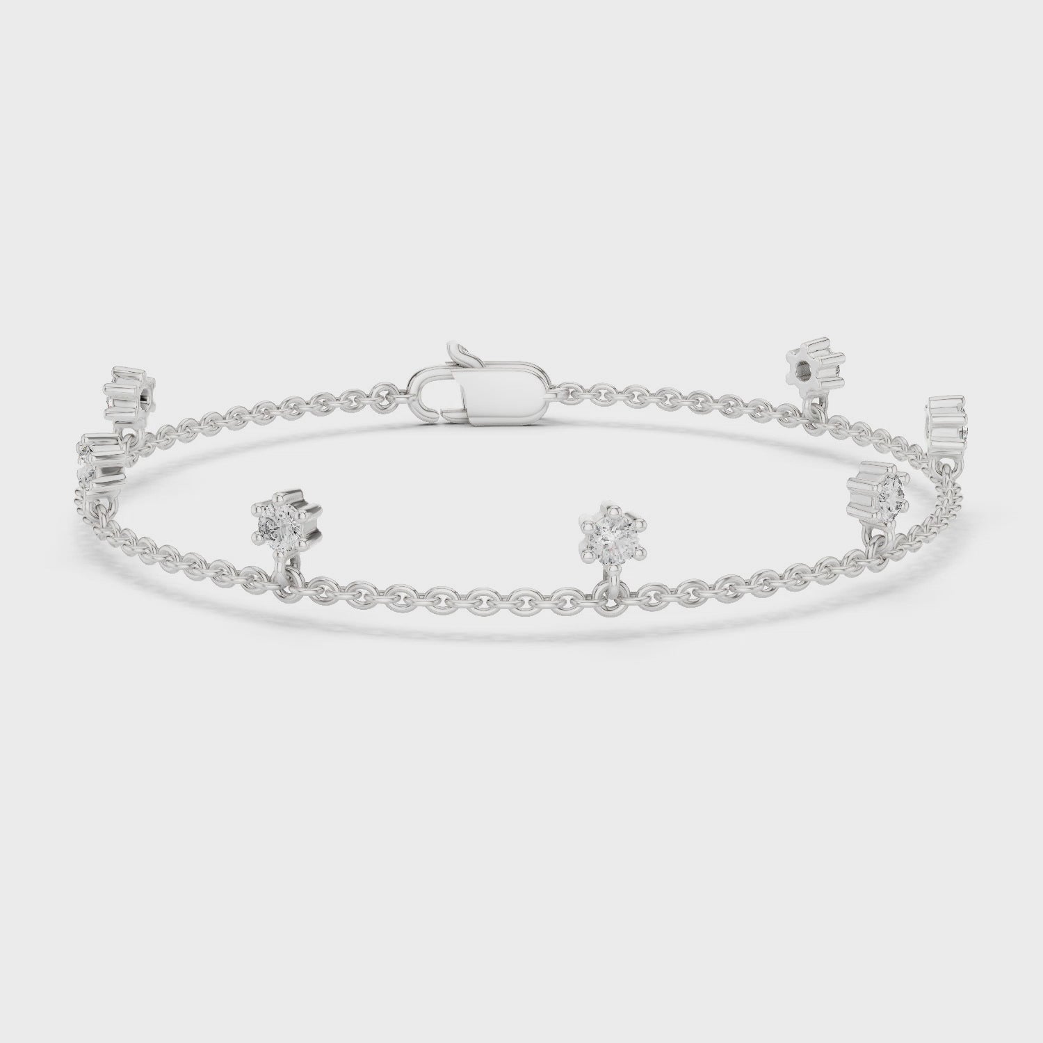 Floating station charm bracelet with prong set round stone station detailing