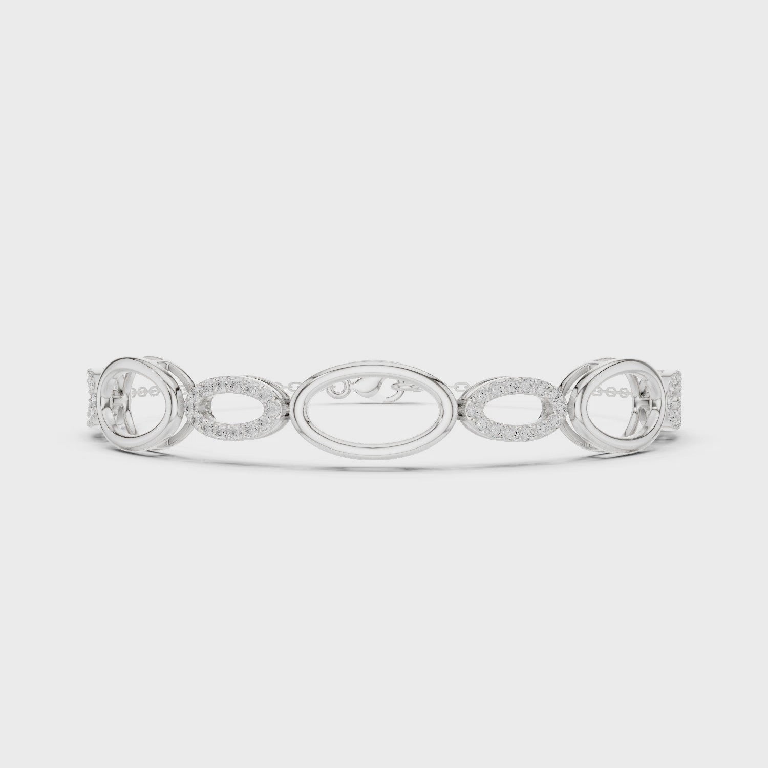 Oval link chain bracelet with open and pave set stone detailing