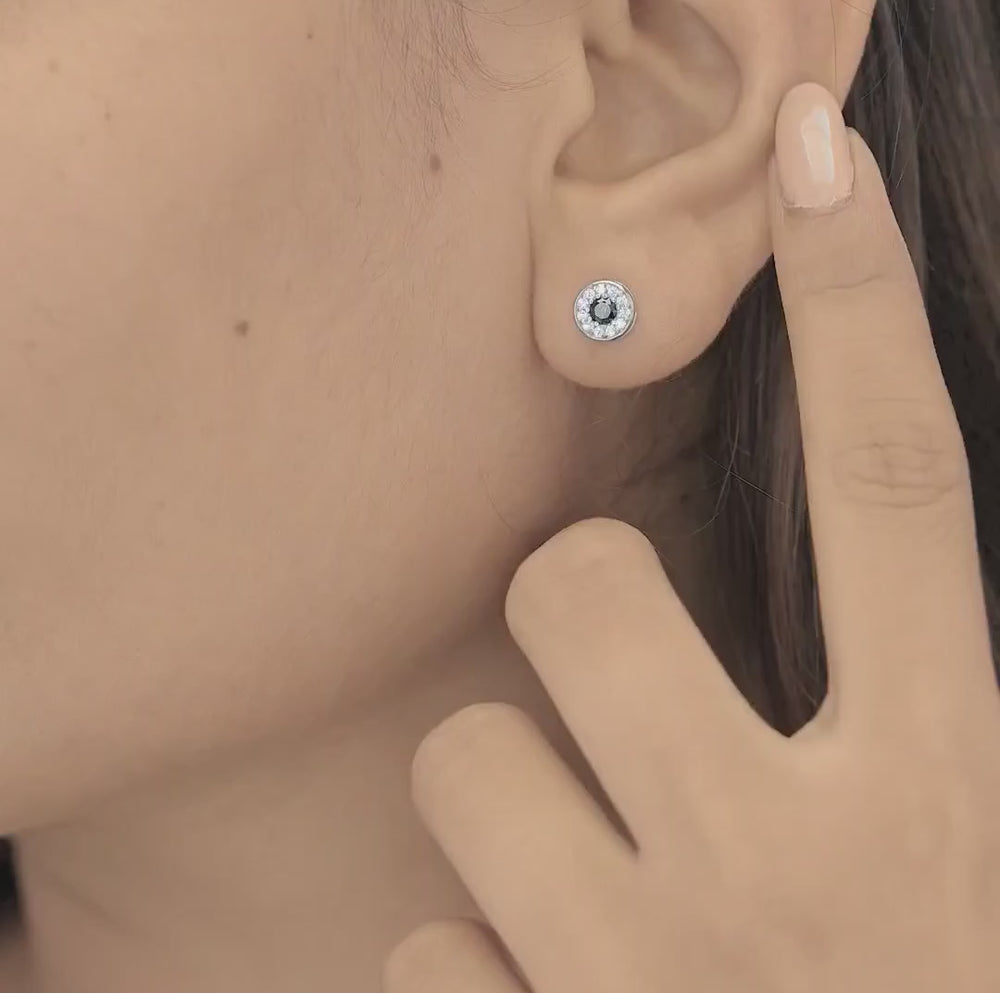 Black halo round cluster stud earrings with white pave surround and circular bezel frame