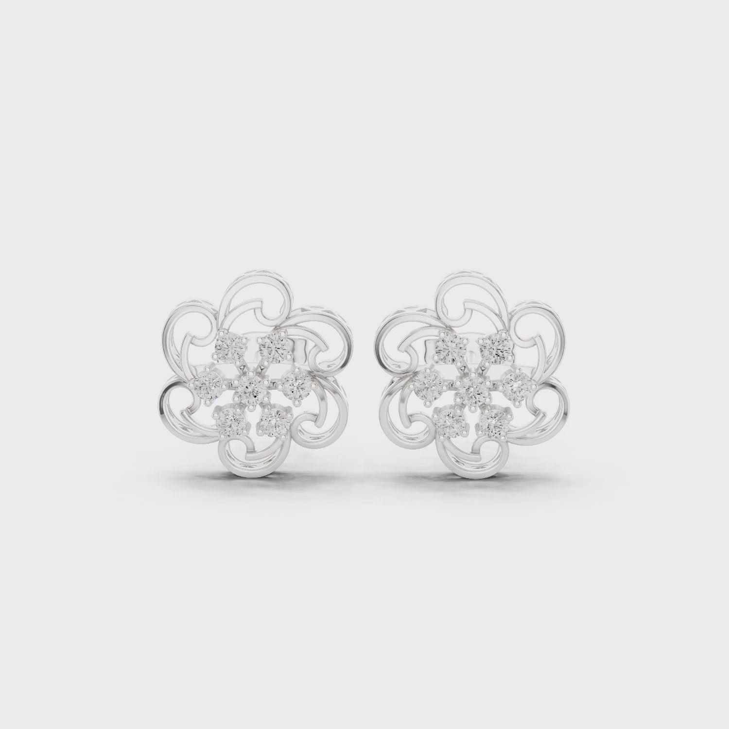Filigree floral stud earrings with intricate scrollwork and open lattice design