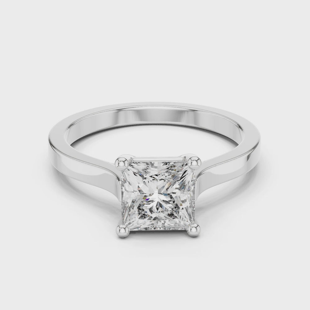 Princess cut solitaire cathedral ring with four claw setting and flat polished band