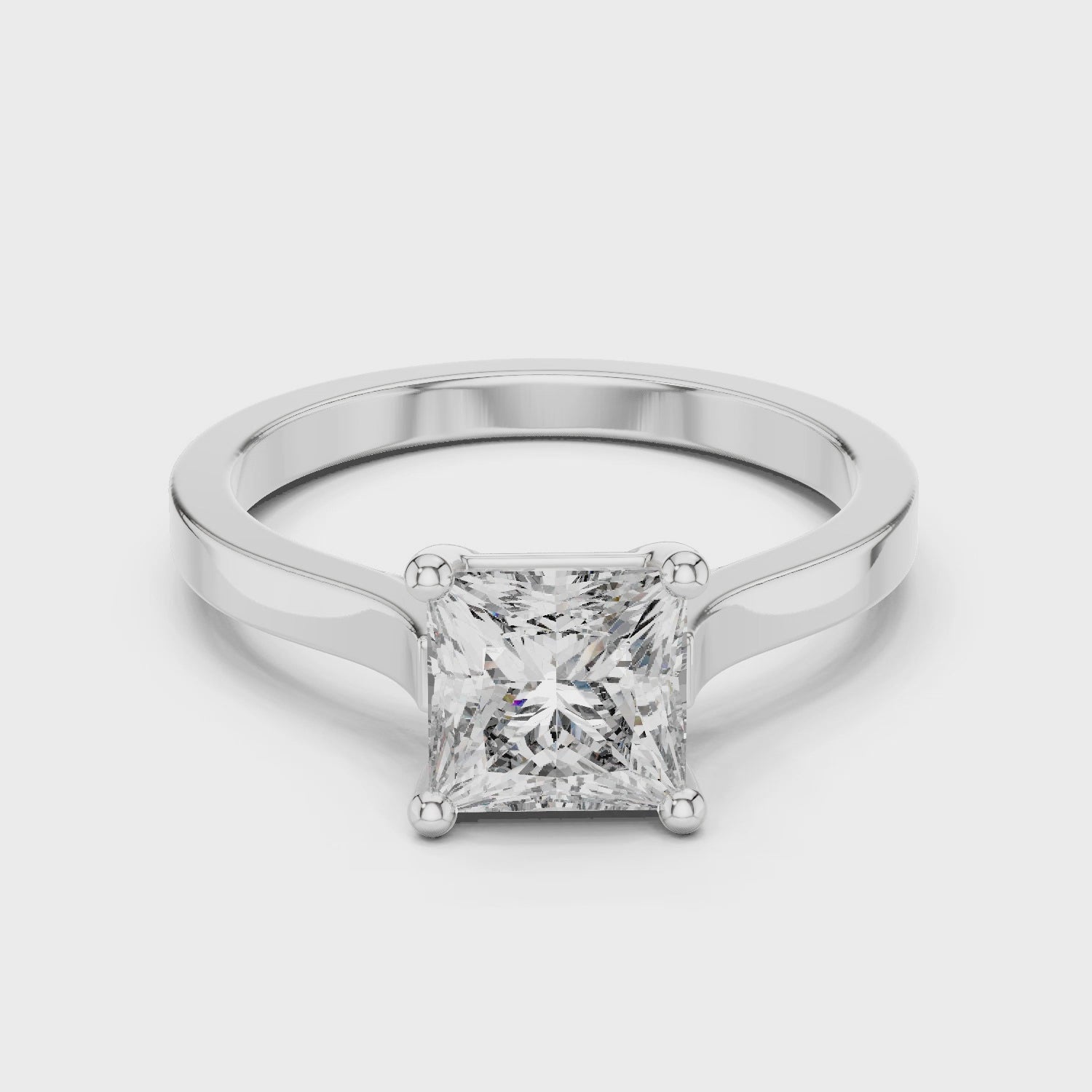 Princess cut solitaire cathedral ring with four claw setting and flat polished band