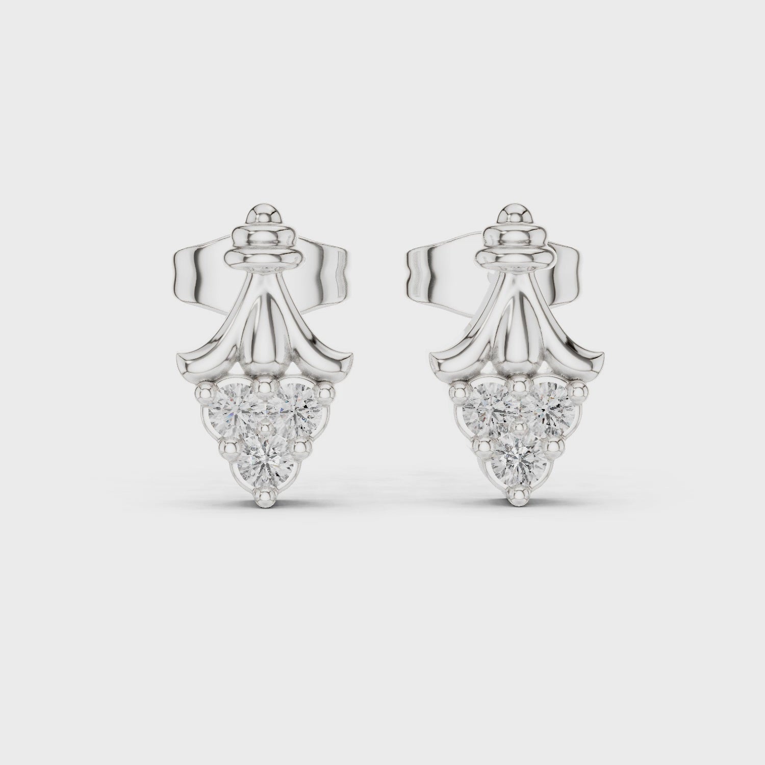 Crown shaped stud earrings with intricate detailing and sparkling stones