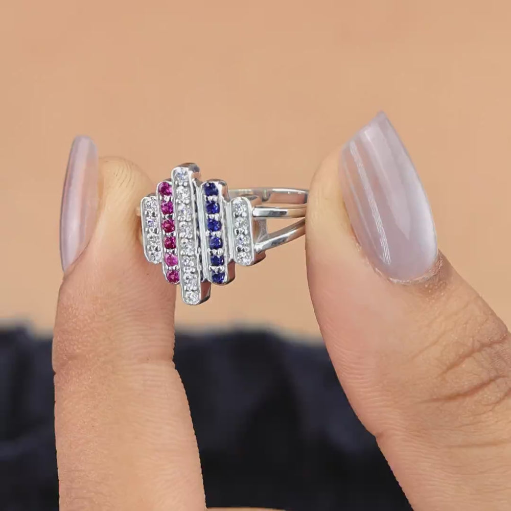 Statement ring featuring vertical rows of clear, pink, and dark blue stones