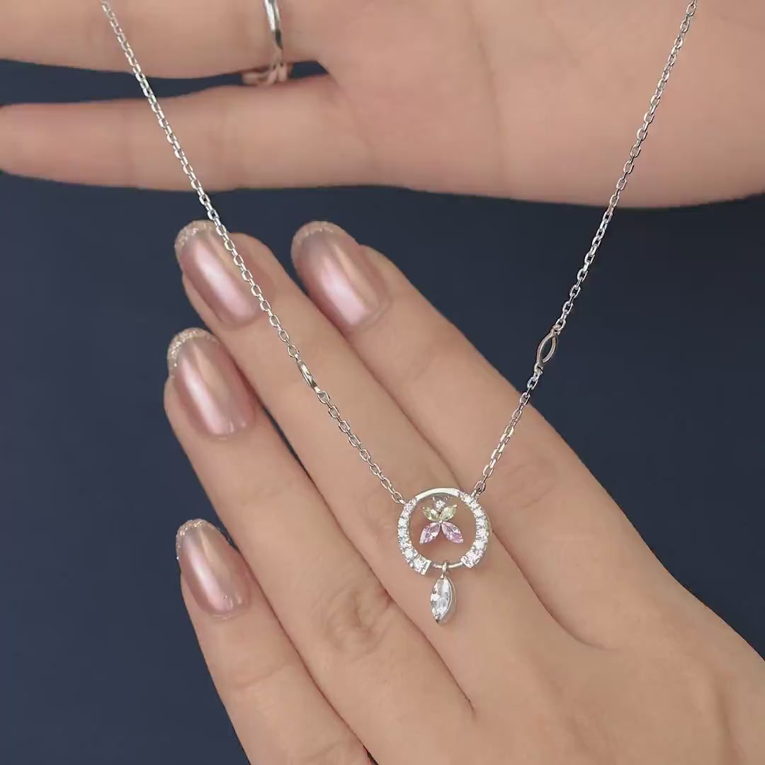 Paved circle pendant enclosing a colorful butterfly with a hanging crystal