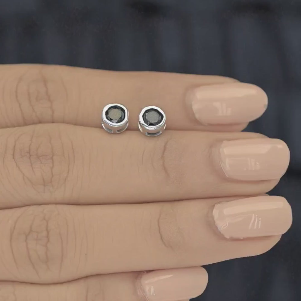 Black round stud earrings with polished circular bezel frame