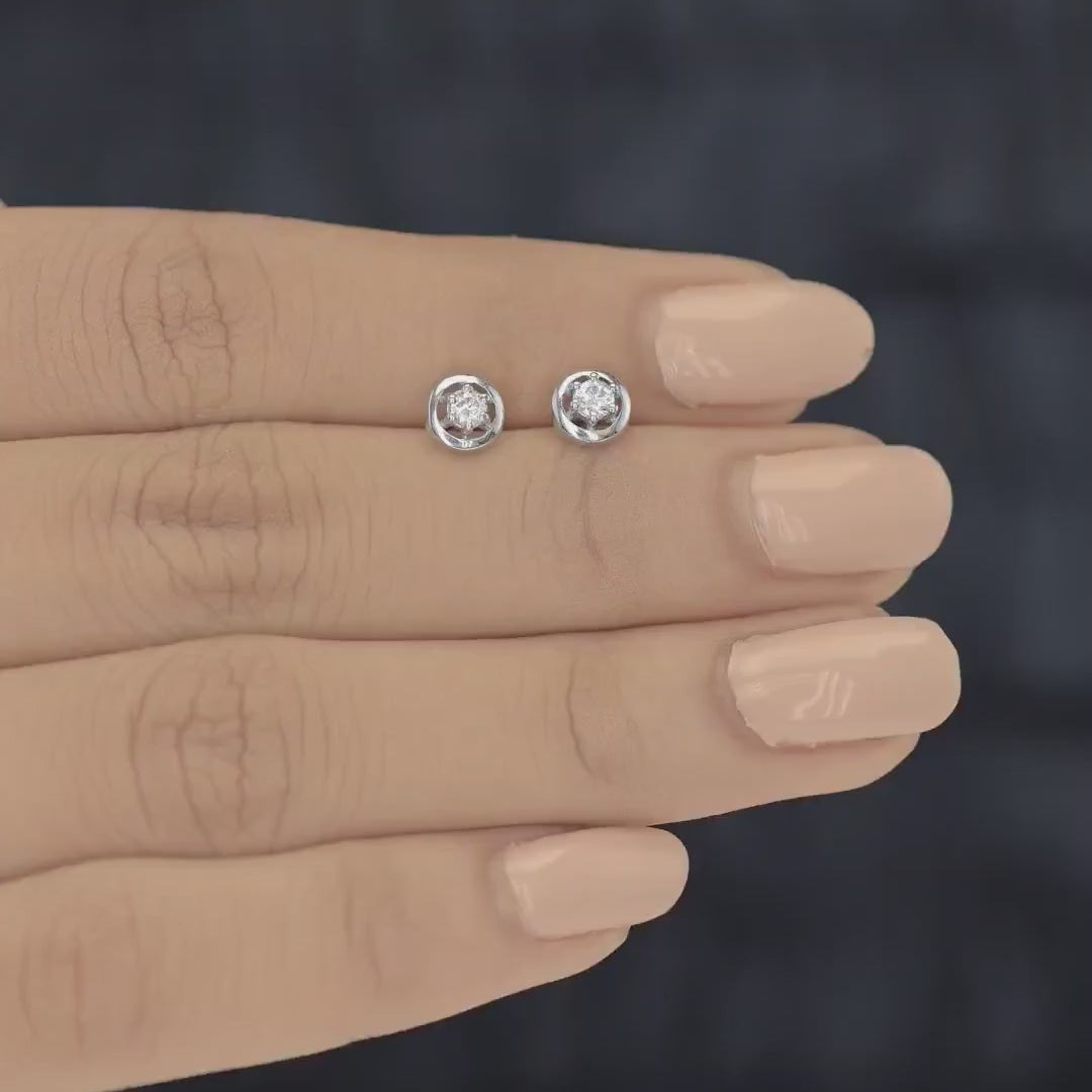 Round halo stud earrings with six claw raised centre and circular border