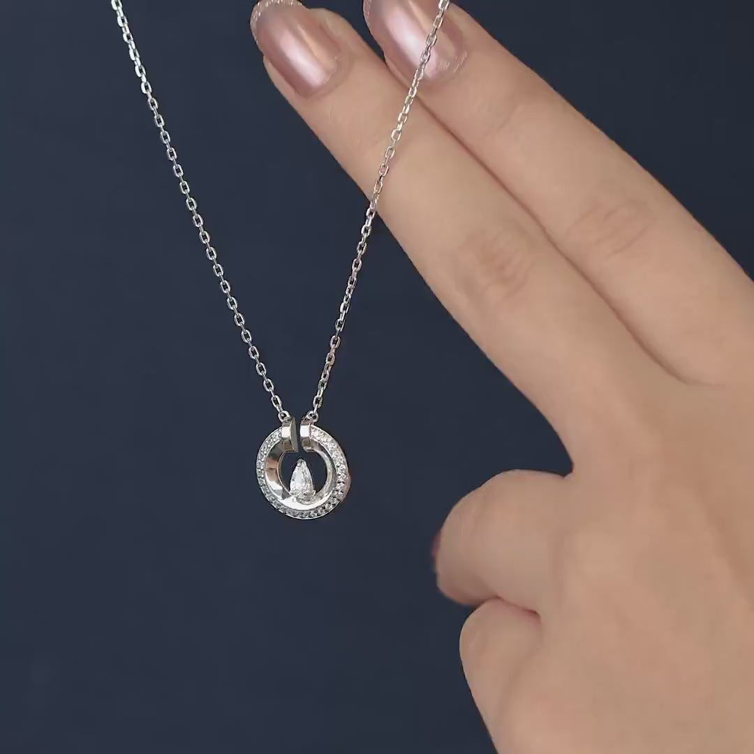 Silver chain necklace with a paved circle pendant enclosing a crystal drop