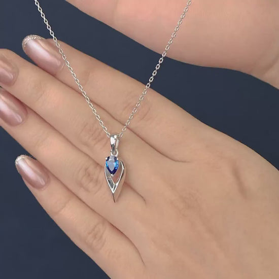 Silver chain necklace with a pointed frame blue gem pendant
