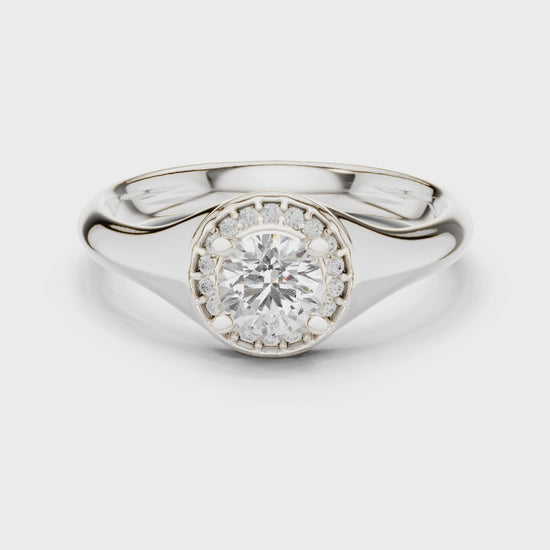 Halo solitaire engagement ring with pave set surround and plain polished band