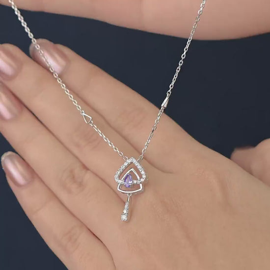 Silver chain necklace with a layered triangular pendant and purple gem