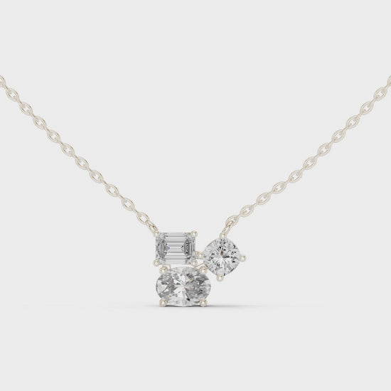 Multi shape cluster diamond pendant necklace with emerald, round and cushion cut stones