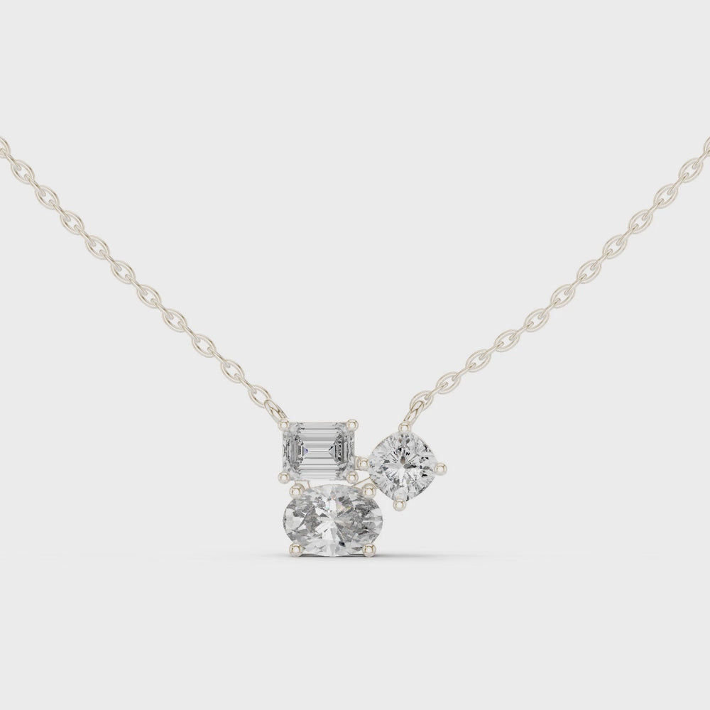 Multi shape cluster diamond pendant necklace with emerald, round and cushion cut stones