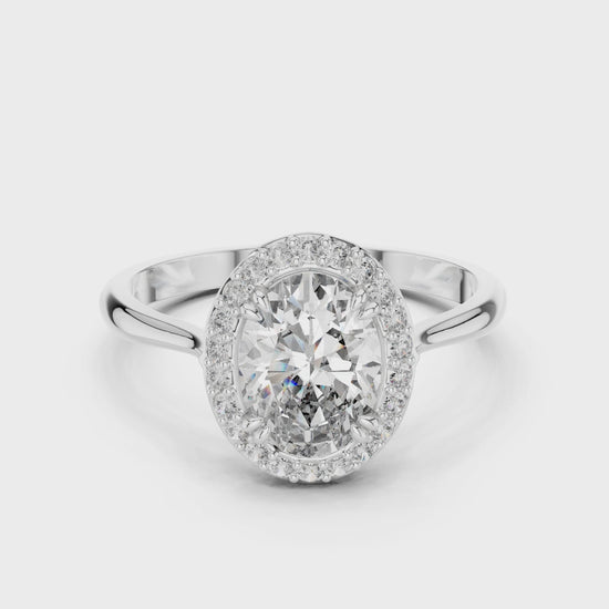 Oval halo solitaire engagement ring with pave surround and plain split shoulder band