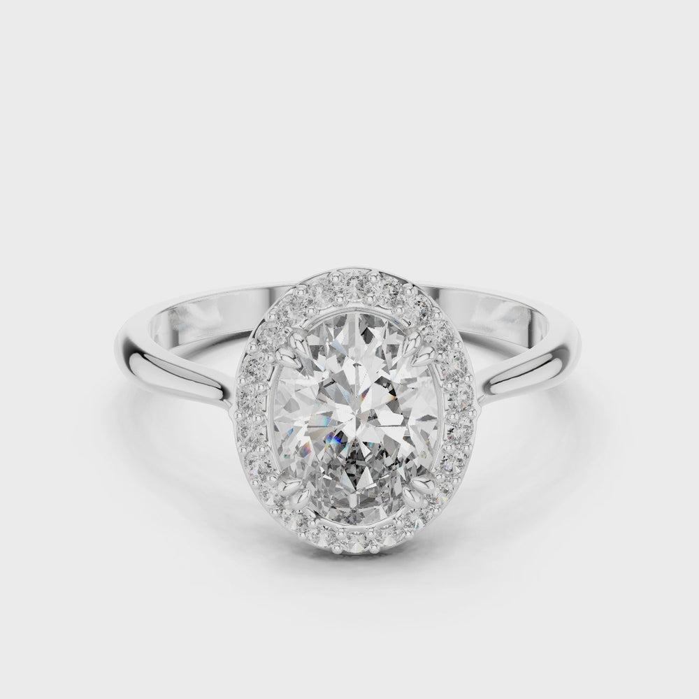 Oval halo solitaire engagement ring with pave surround and plain split shoulder band